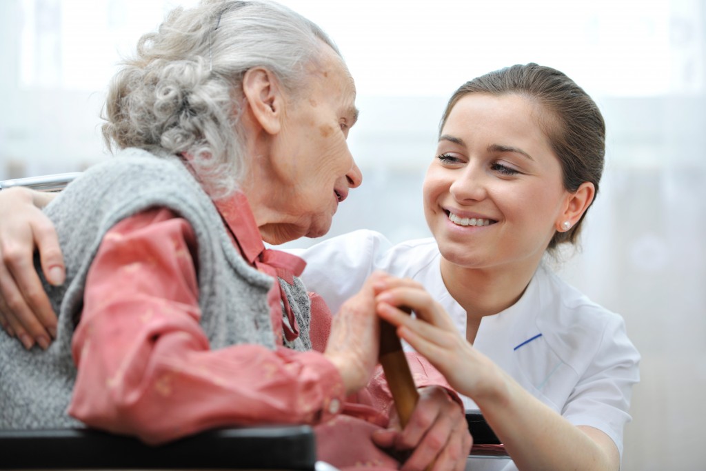 Senior and nurse smiling